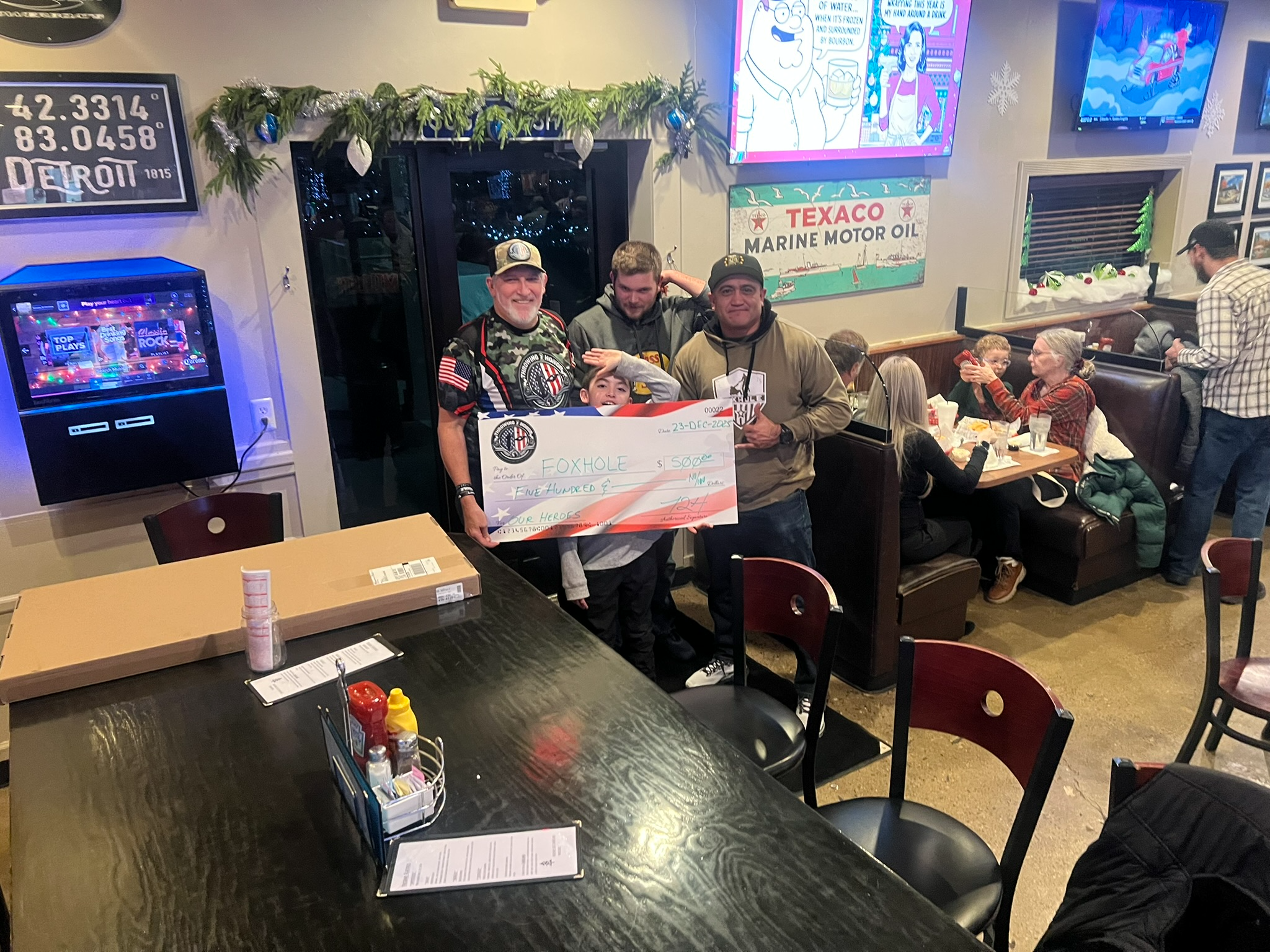 Throwing 2 Honor presenting a 500 dollar donation check to Foxhole