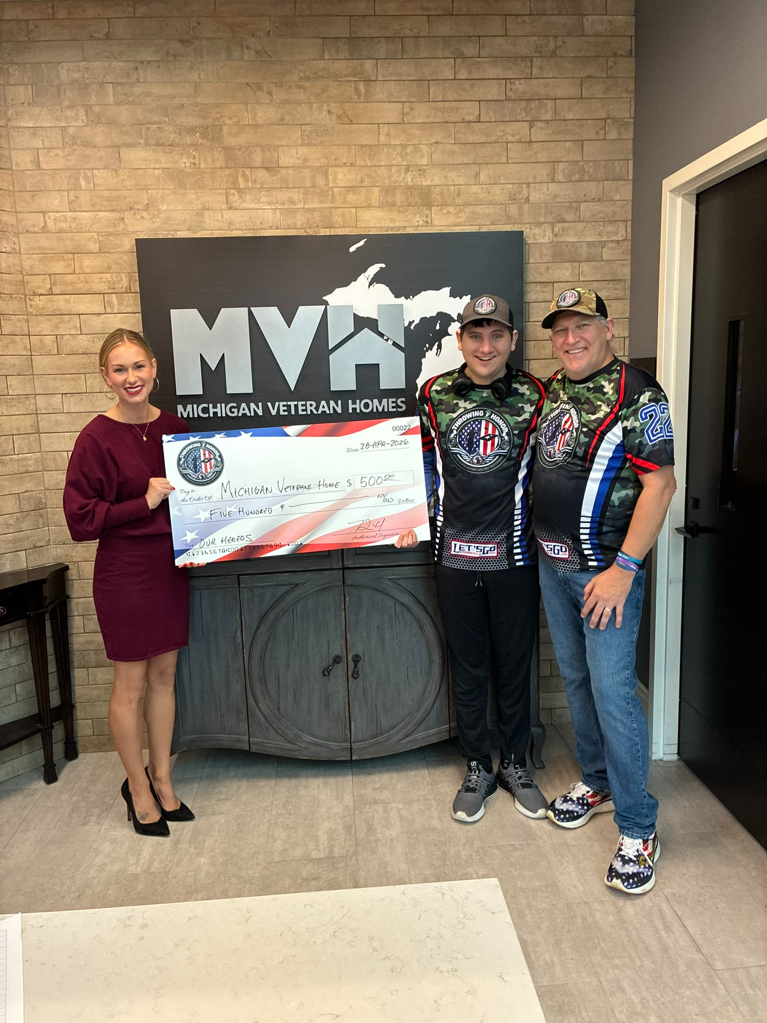 Throwing 2 Honor presenting a 500 dollar donation check to Michigan Veteran Homes on April 28, 2026
