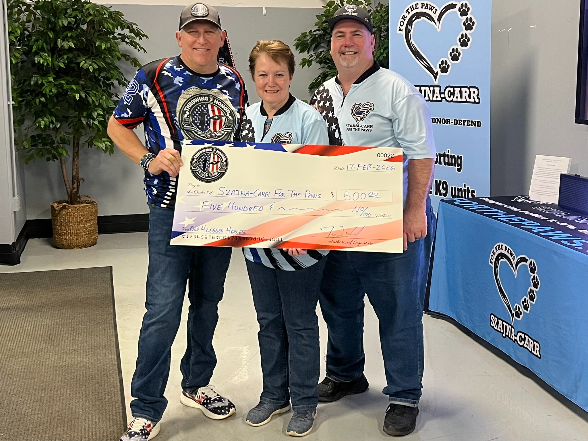 Throwing 2 Honor presenting a 500 dollar donation check to Szajna-Carr For the Paws on February 17, 2026