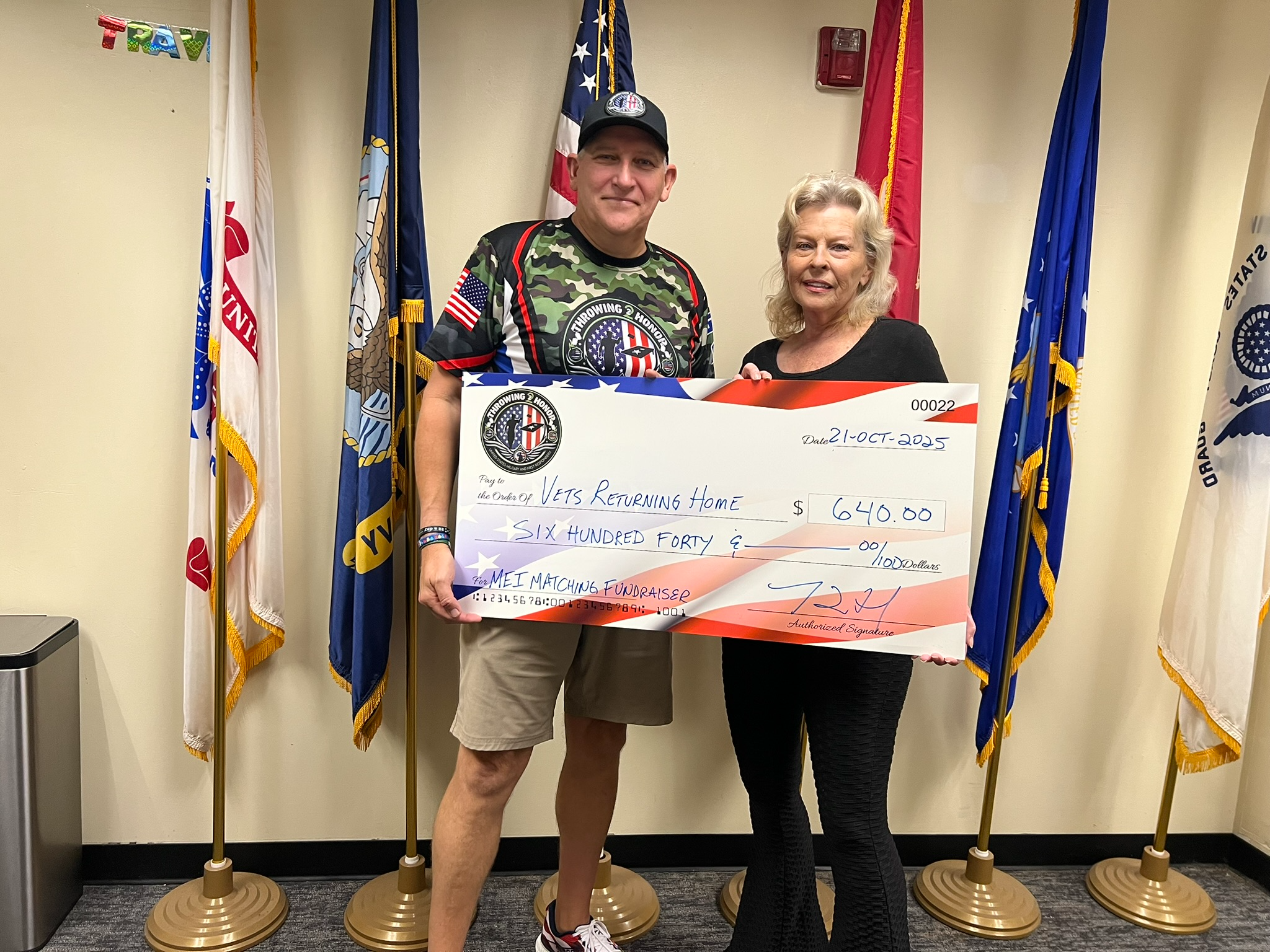 Throwing 2 Honor presenting a donation check to Vets Returning Home with owner Sandy Bower